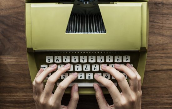 Aerial view a woman using a retro typewriter